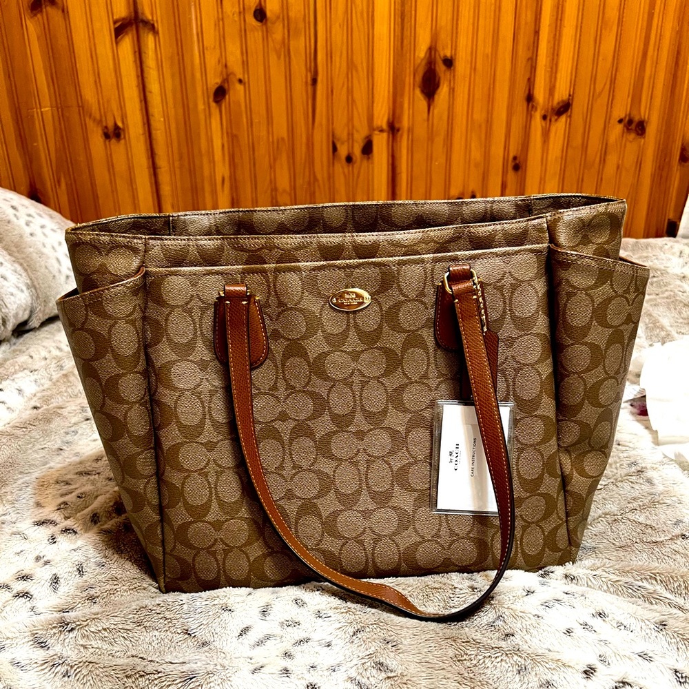 Coach baby bag. Includes: detachable strap & changing pad.